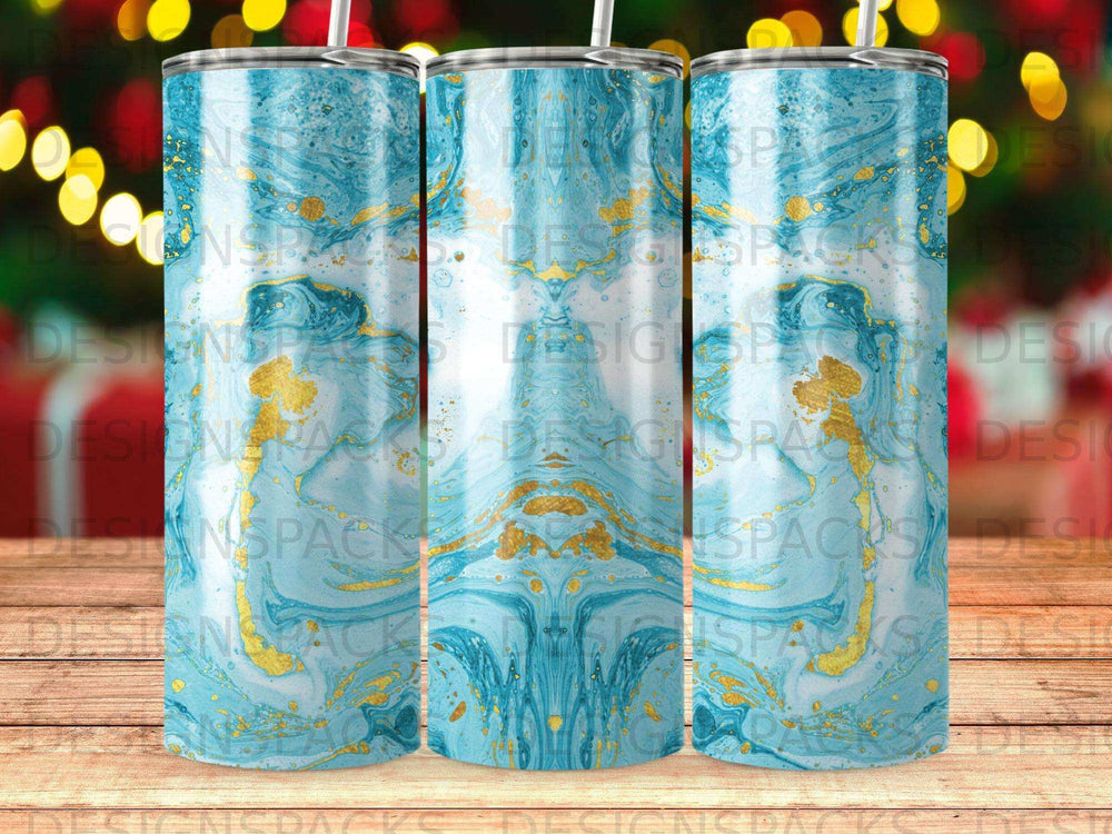 Blue and gold marbled tumbler with bokeh background.