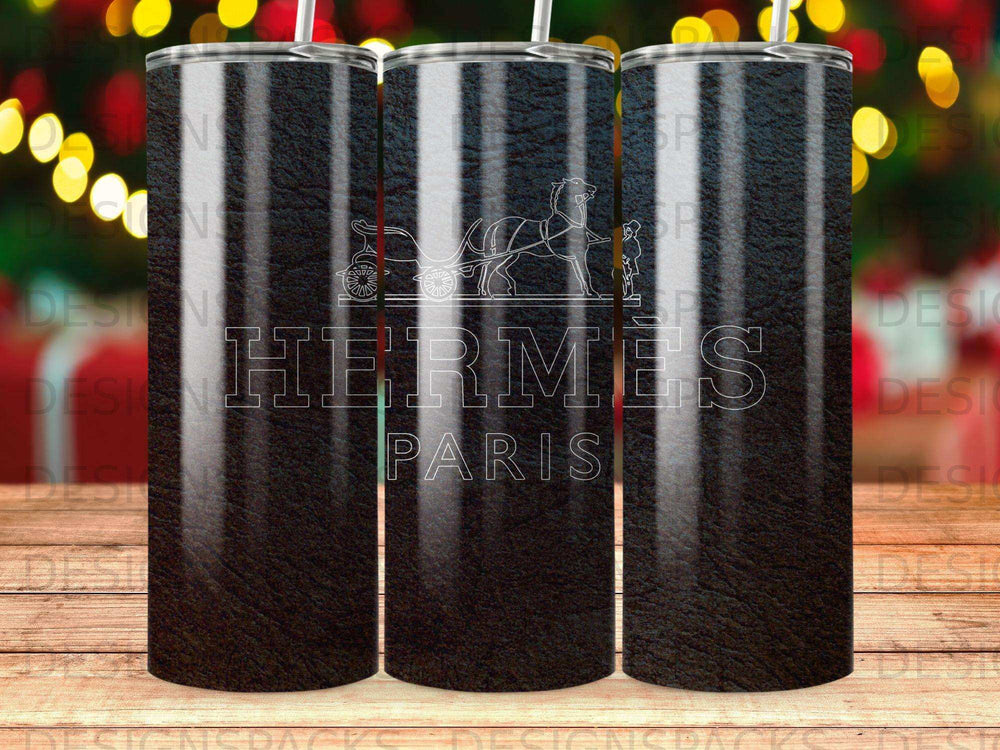 Hermès Paris logo on a dark, textured tumbler with blurred colorful lights in the background.
