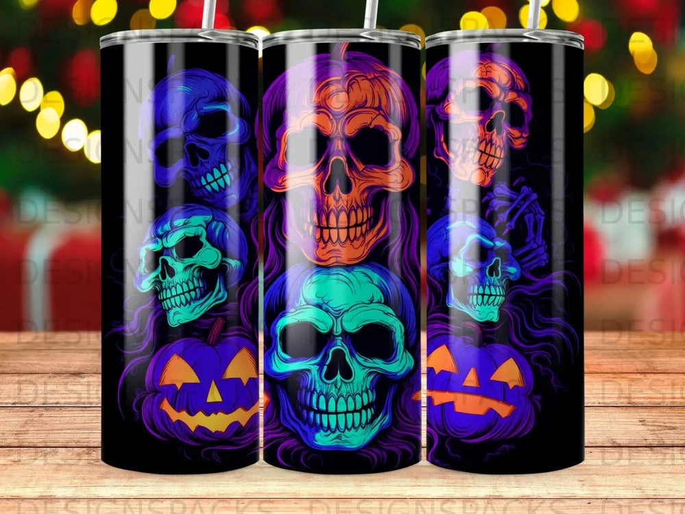 Three tumblers with Halloween skull and pumpkin designs in blue, purple, and orange.