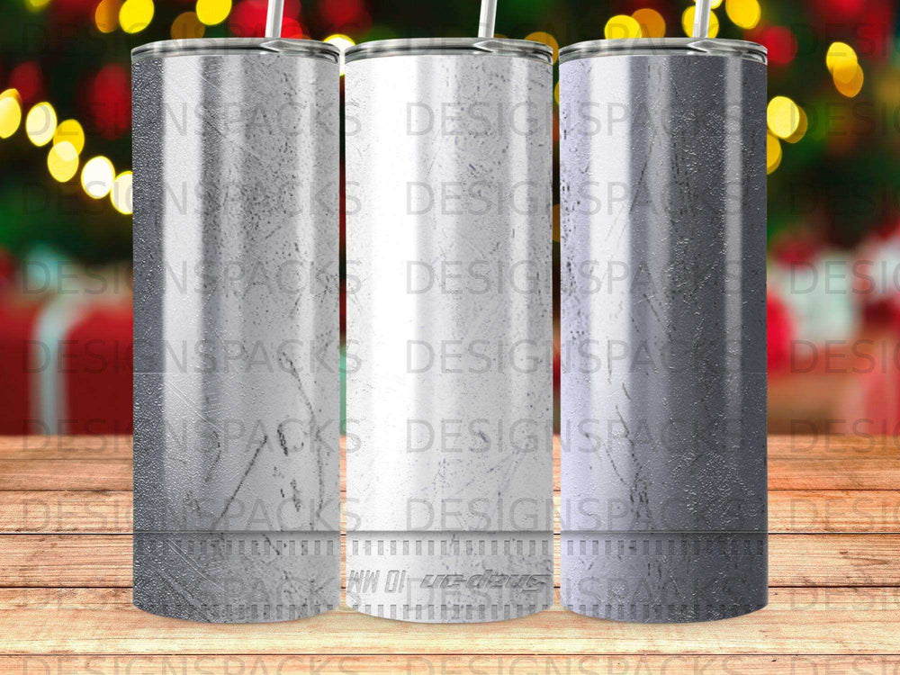 Three tumblers with textured bottoms and blurred holiday lights in the background.
