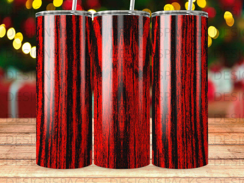 Three red and black striped tumblers with straws on a blurred bokeh background.