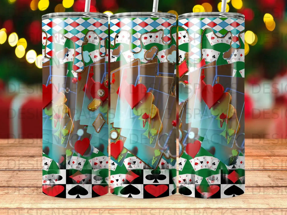 Tumbler with playing card suits, dice, and festive bokeh lights.