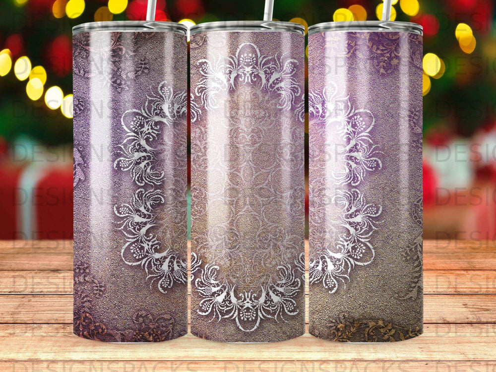 Three tumblers with ornate white floral patterns on textured purple and gold backgrounds.