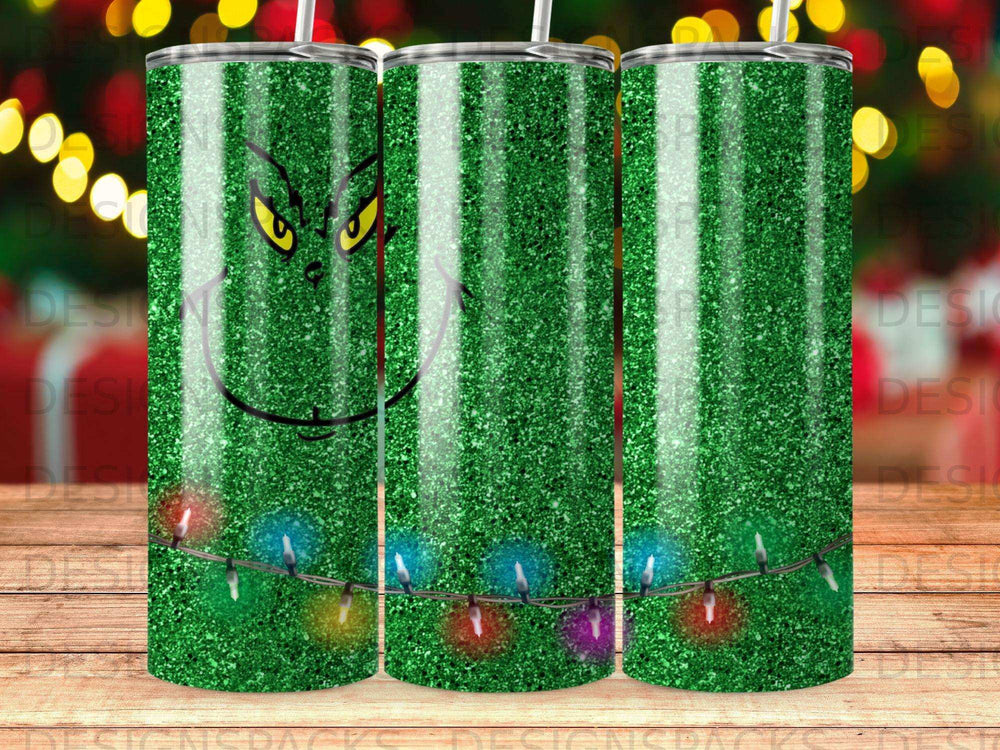 Green glitter tumbler with The Grinch's face and colorful Christmas lights.