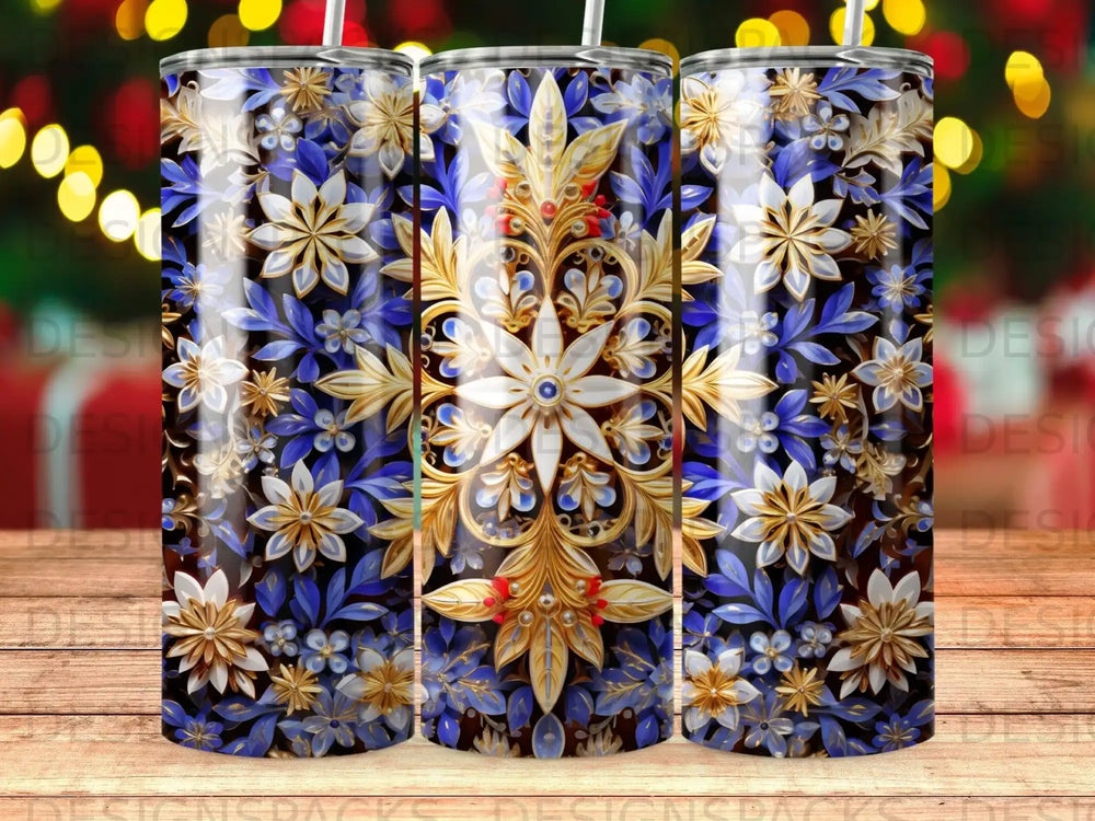 Three tumblers with a gold and blue floral pattern against a dark background.