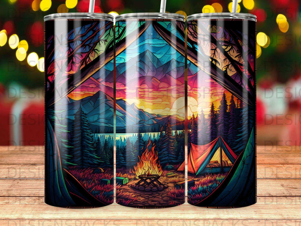 Tent, campfire, and mountains viewed through a colorful forest scene at sunset.