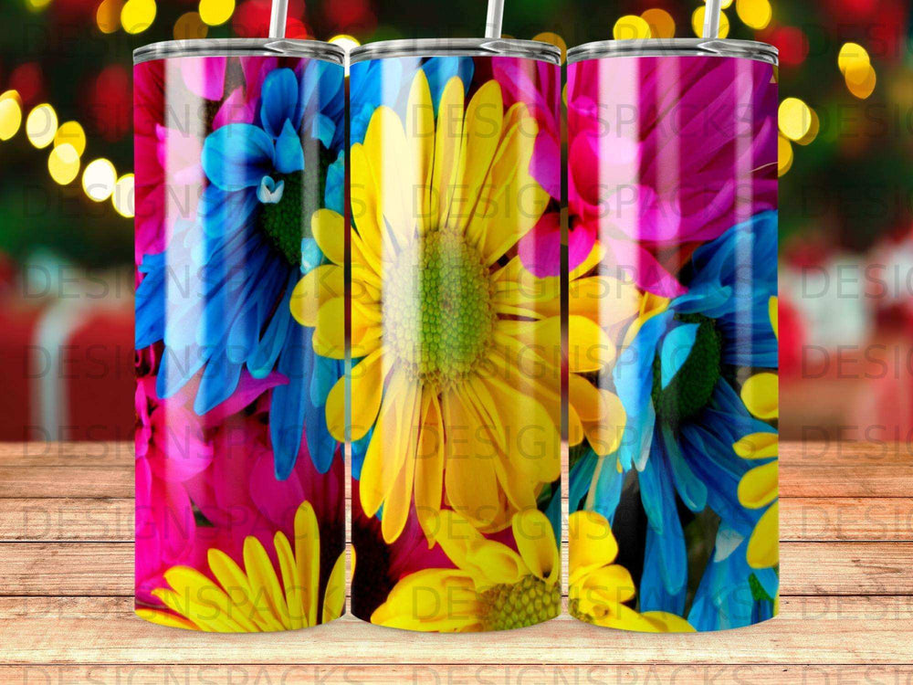 Three tumblers with bright floral patterns, featuring yellow and blue daisies.