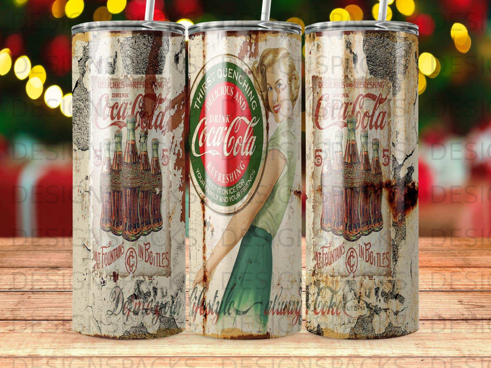 Three vintage Coca-Cola cans with retro design and text.