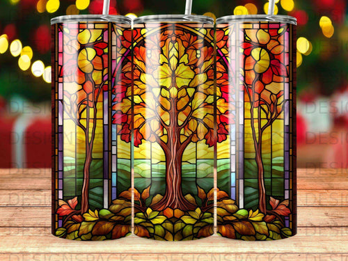 Stained glass tumbler with a vibrant autumn tree and fall leaves.