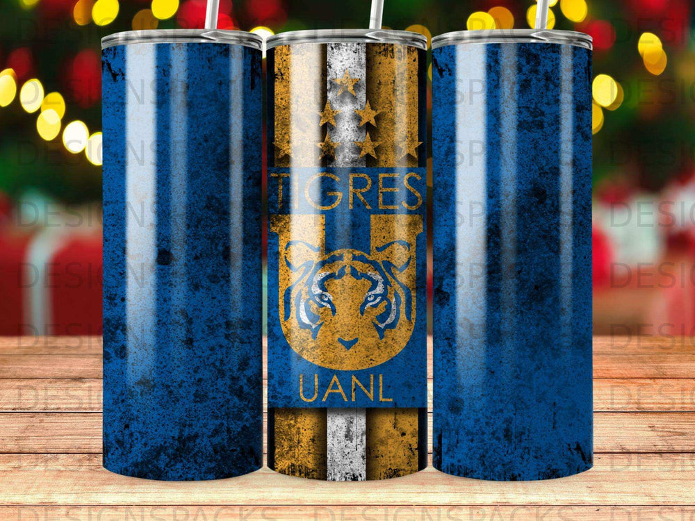 Tigres UANL logo on a blue distressed tumbler with festive bokeh background.