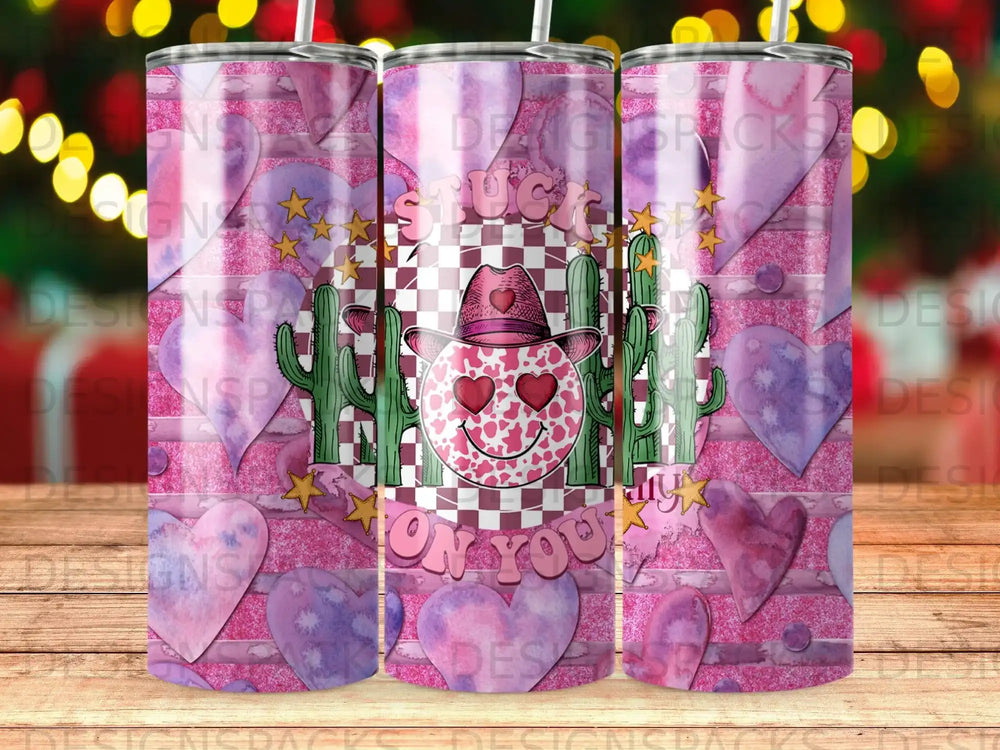 Pink cowboy hat tumbler with hearts, cacti, and "Stuck On You" text.