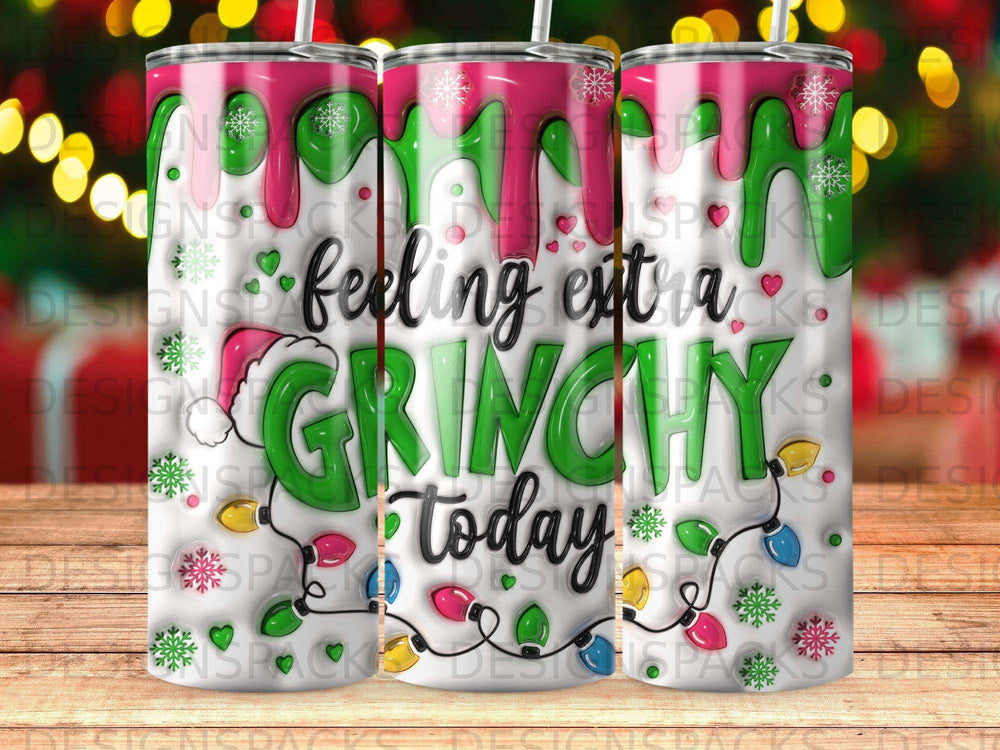 Green and pink Grinch-themed tumbler with festive lights and text "feeling extra GRINCHY today".
