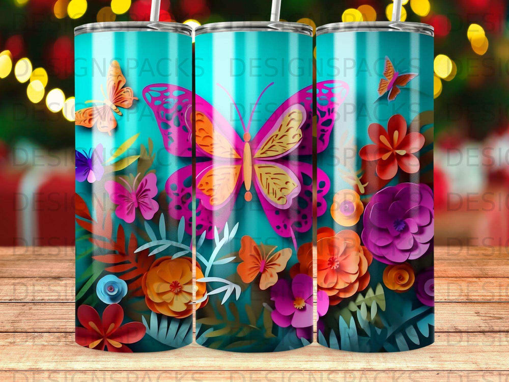 Three tumblers with a vibrant floral and butterfly design on a teal background.