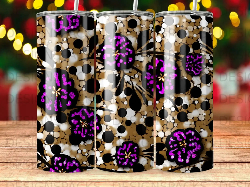 Three tumblers with a floral and polka dot pattern against a bokeh background.