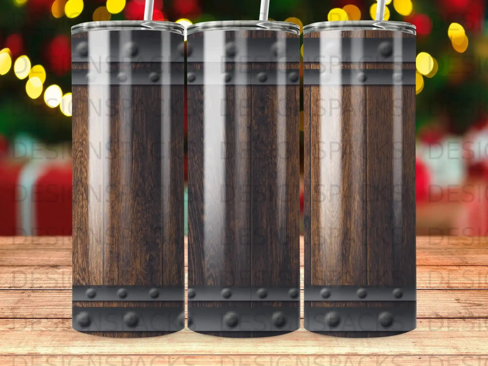 Three wooden barrel tumblers with metal bands on a bokeh background.