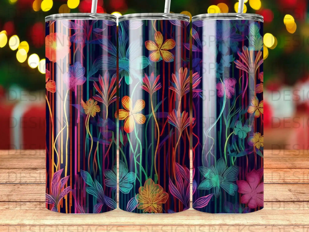 Dark navy background with colorful floral and stripe pattern on three tumblers.