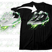 Black t-shirt with graphic of green and white sneakers with glowing green accents.
