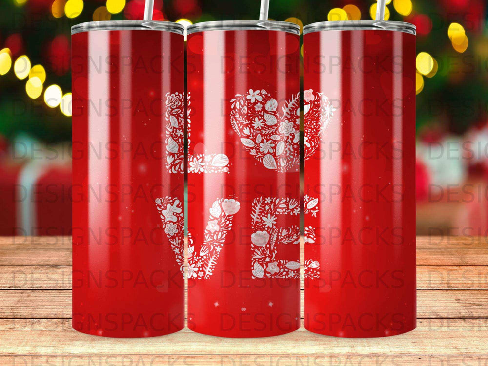 Red tumbler with a white floral "love" design.