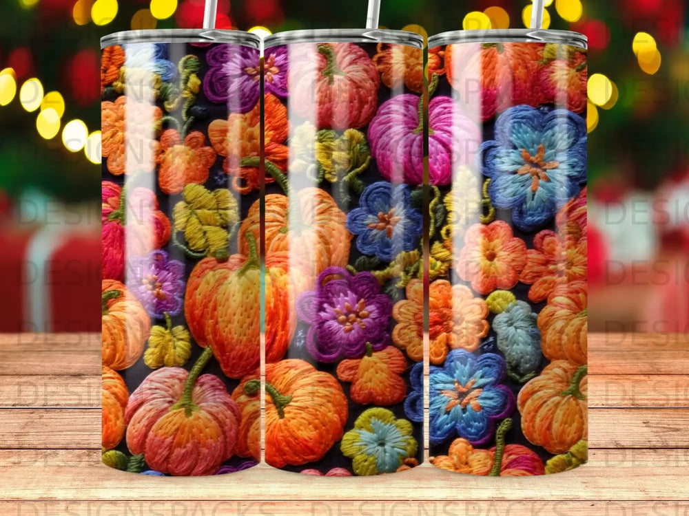 Three tumblers with a colorful embroidered pumpkin and floral pattern.