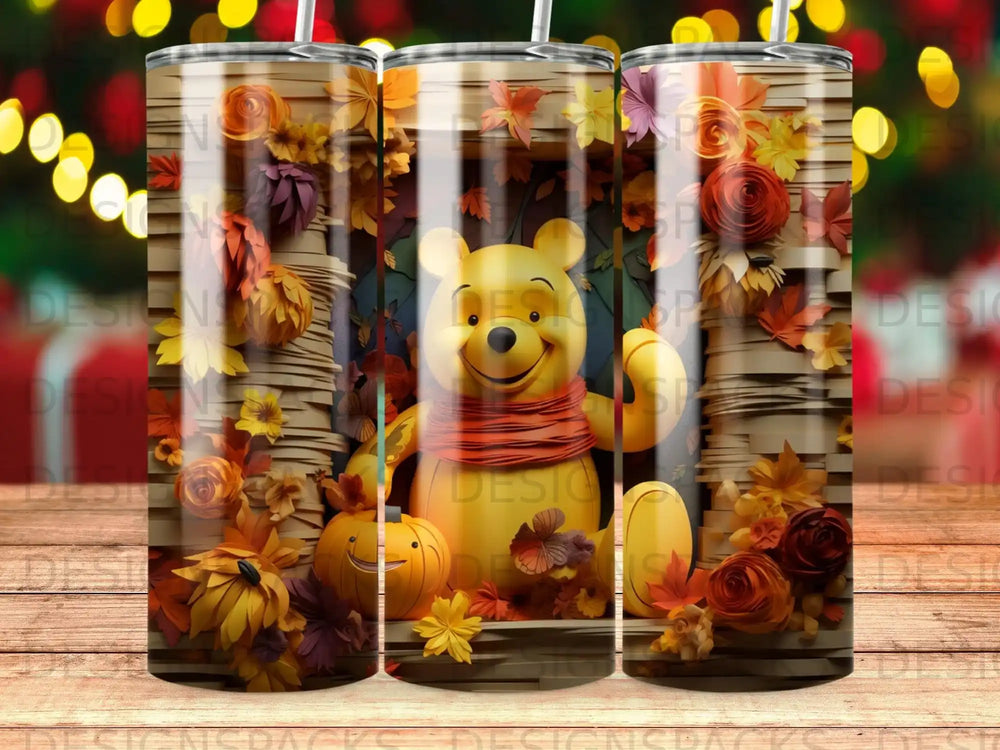 Winnie the Pooh character on a tumbler surrounded by fall leaves and pumpkins.