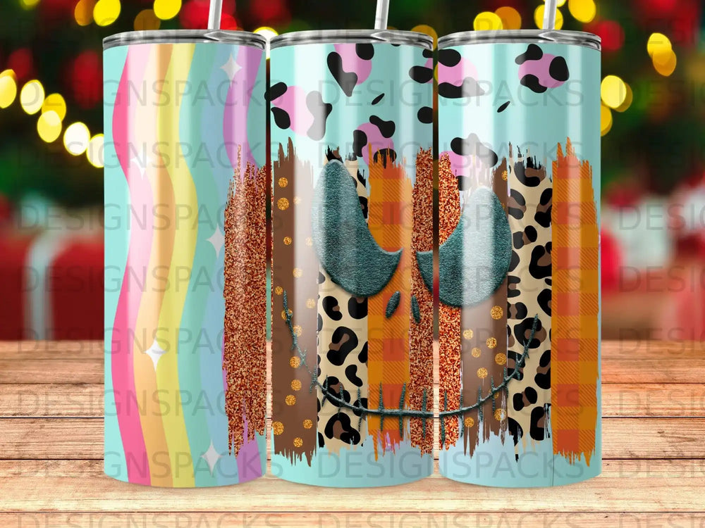 Tumbler with pumpkin face, leopard print, and colorful stripes.
