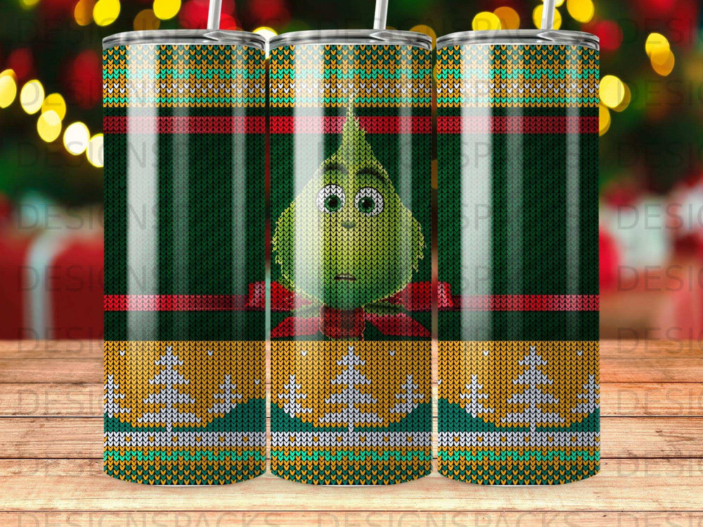 Grinch character on a holiday-themed patterned tumbler with a knit design.