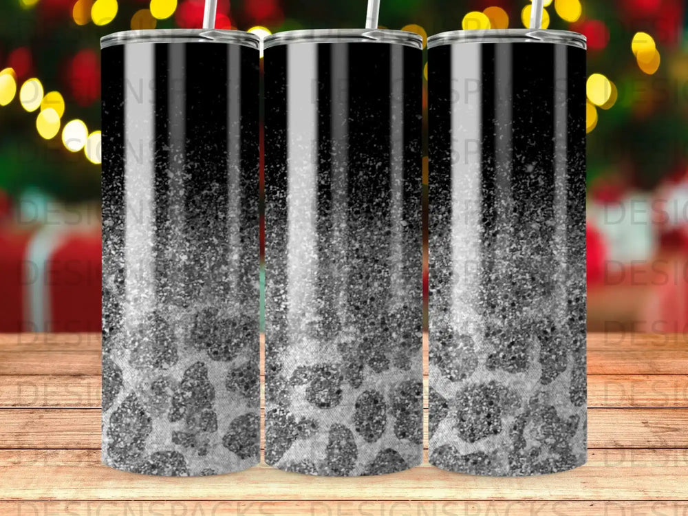 Patterned tumbler with leopard spots and glitter details on a black background.