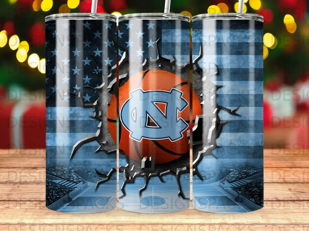 Cracked American flag tumbler with UNC Tar Heels logo and basketball court background.