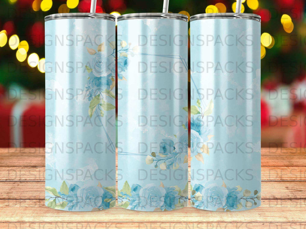 Three tumblers with a blue floral design and repeating "DESIGNSPACKS" watermark.