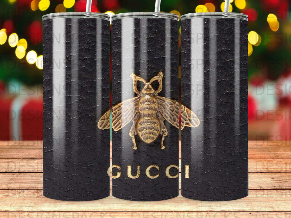 Black Gucci tumbler with a gold bee emblem.