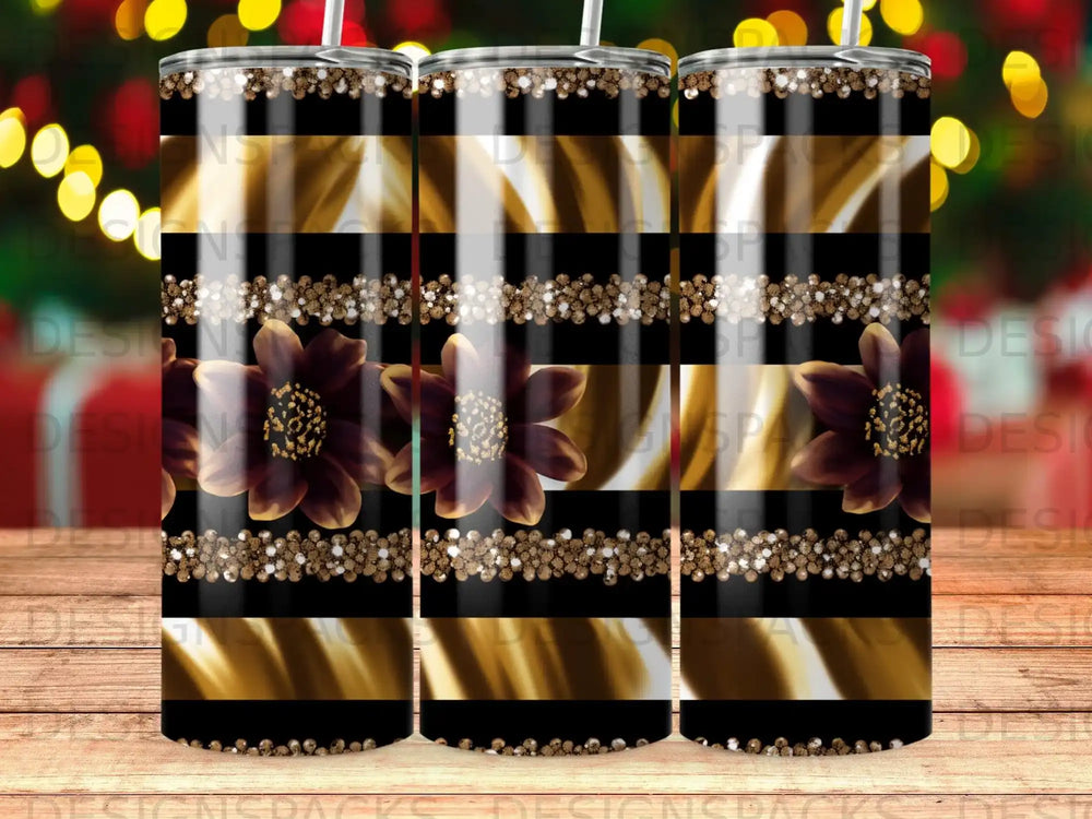 Tumbler with black and gold stripes and dark floral accents.