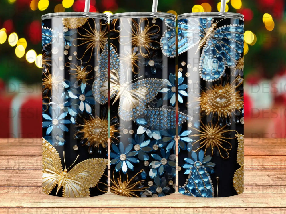Three tumblers with gold and blue butterflies and floral designs.
