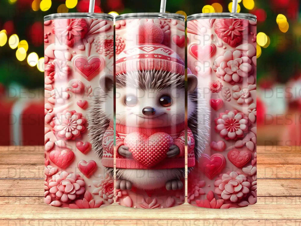 Hedgehog in a knitted hat holding a heart on a pink, heart-themed tumbler.