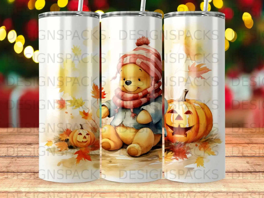Winnie the Pooh in a hat and scarf sitting by pumpkins with autumn leaves.