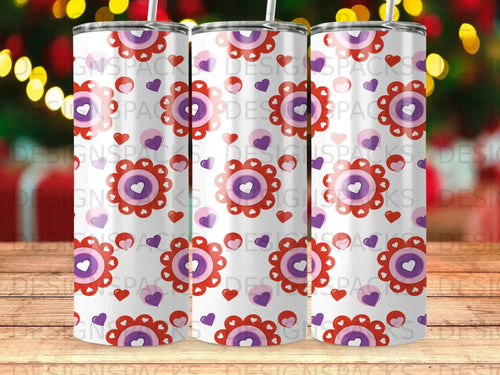 White tumbler with repeating pattern of purple and red hearts and flowers.