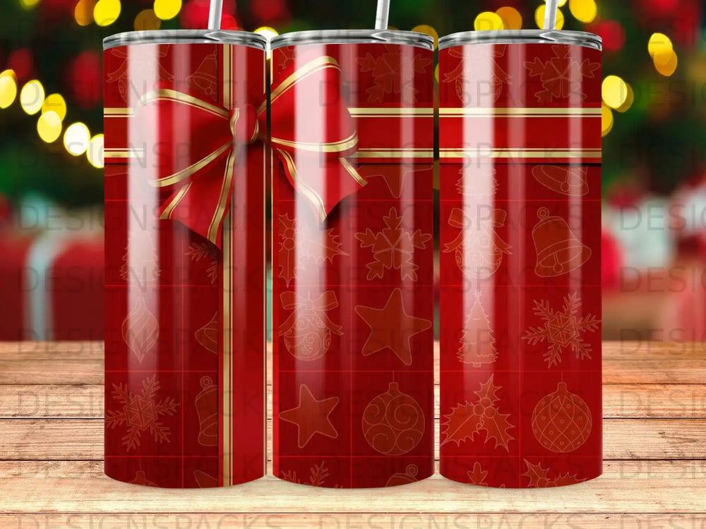 Red tumbler with Christmas gift wrap pattern and gold ribbon.