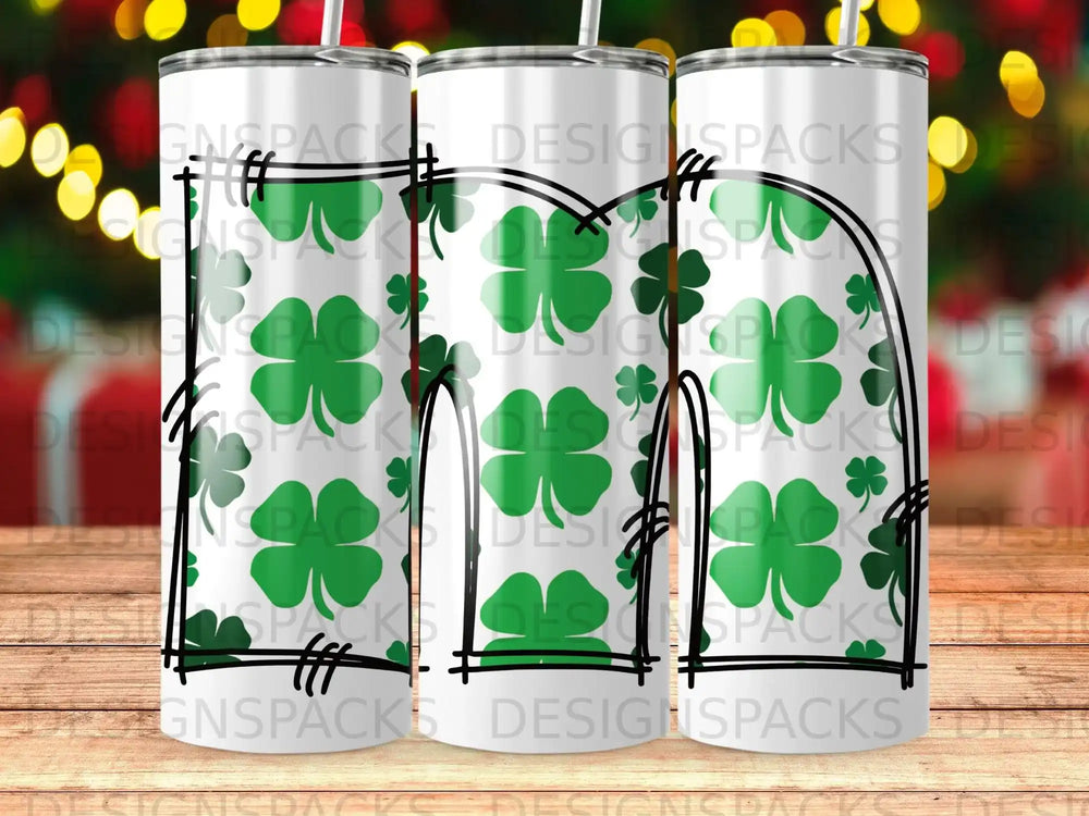 Tumbler with a pattern of green shamrocks against a white background.