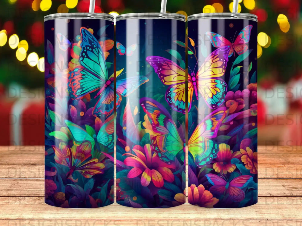 Three tumblers with vibrant, colorful butterflies and flowers.