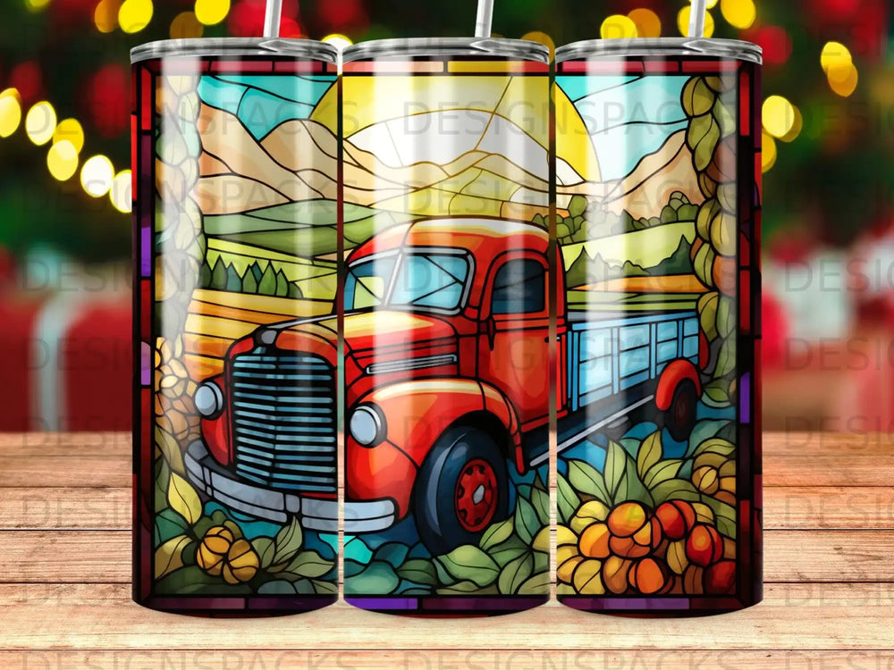 Red stained glass truck in a sunny field with fruit and mountains.