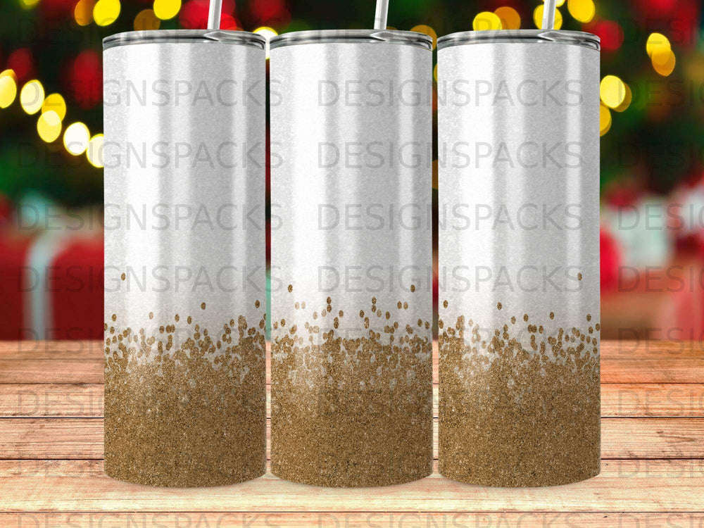 Three white tumblers with gold glitter gradient bottoms, studio lighting.