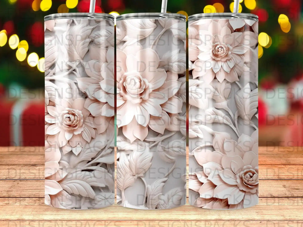 Three pink floral patterned tumblers on a wooden background.
