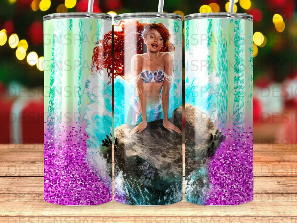 Mermaid with red hair sitting on a rock in glittery water.