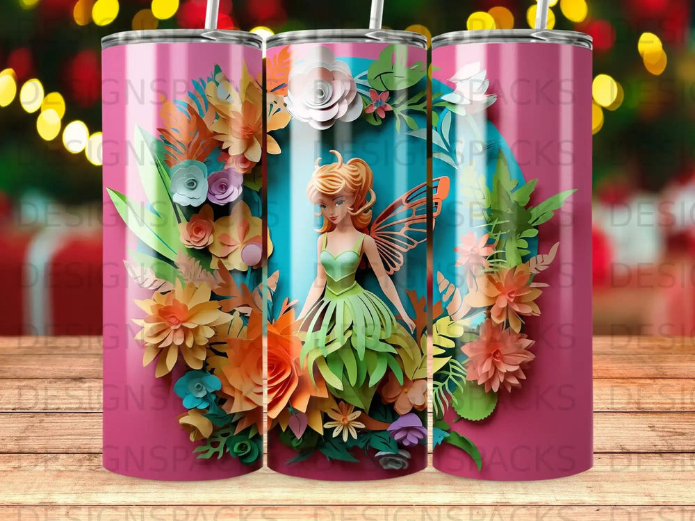 Pink tumbler with a fairy surrounded by colorful paper flowers and leaves.