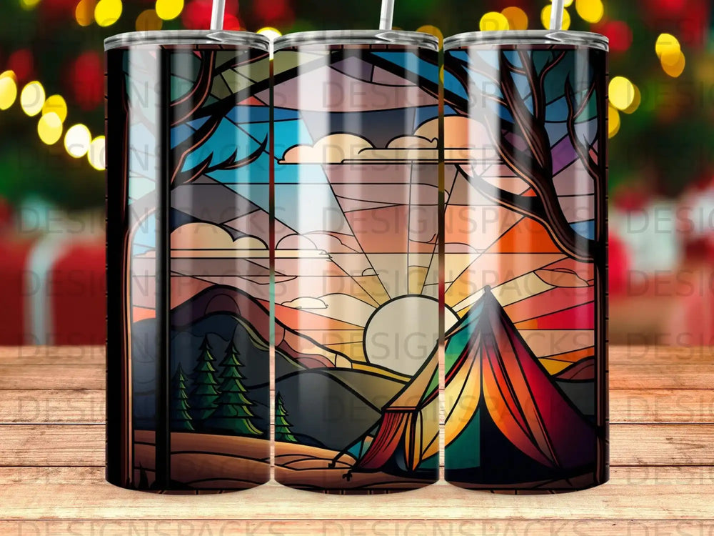 Tannin tumbler with stained glass forest scene and tent at sunset.