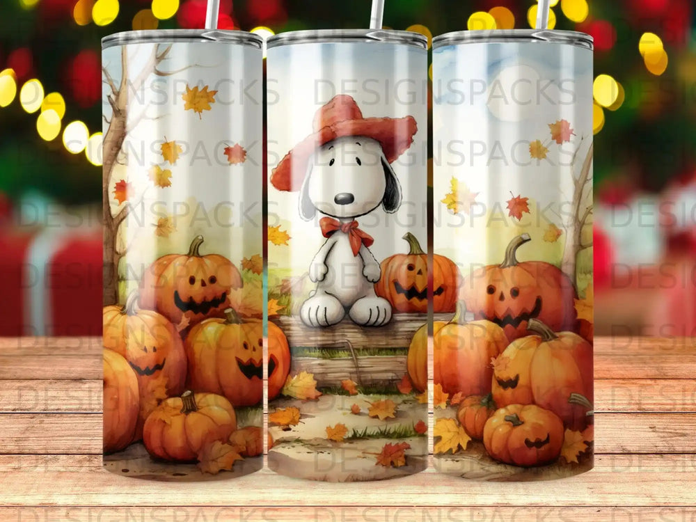 Snoopy wearing a hat sits amongst pumpkins and autumn leaves.