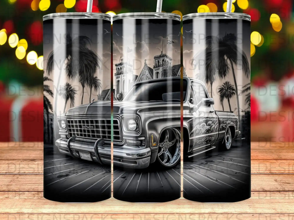 Silver pickup truck with palm trees and a building in the background.