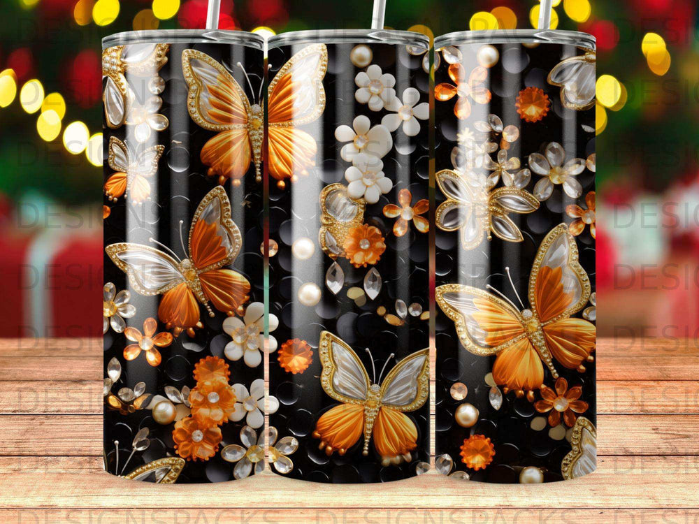 Three tumblers with a gold butterfly and floral pattern on a dark background.