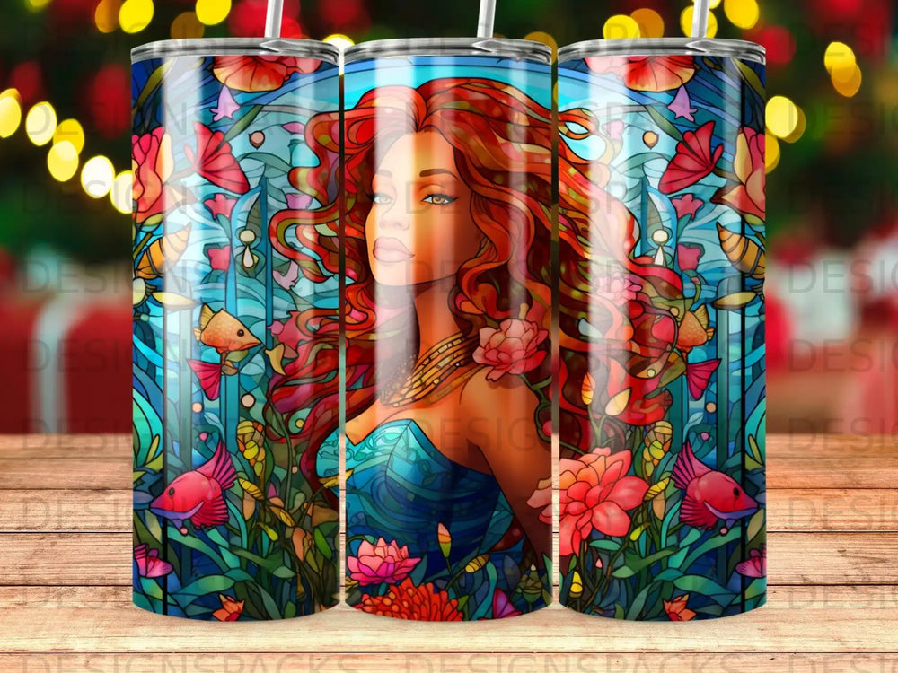 Woman with red hair in a blue dress surrounded by colorful underwater flora and fauna.