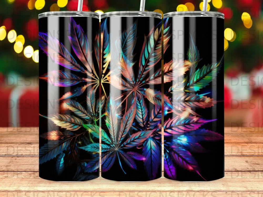 Three tumblers with colorful marijuana leaf design and festive bokeh lights background.