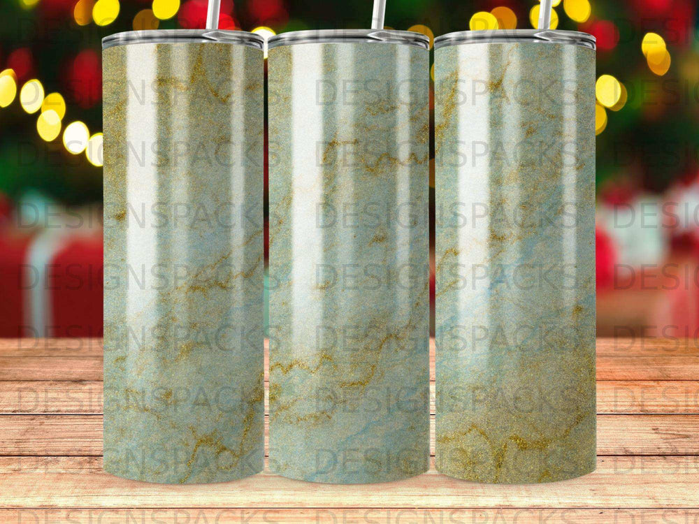 Three tumblers with a gold and blue marbled design and "DESIGNSPACKS" watermark.